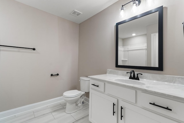 bathroom with vanity, toilet, and walk in shower