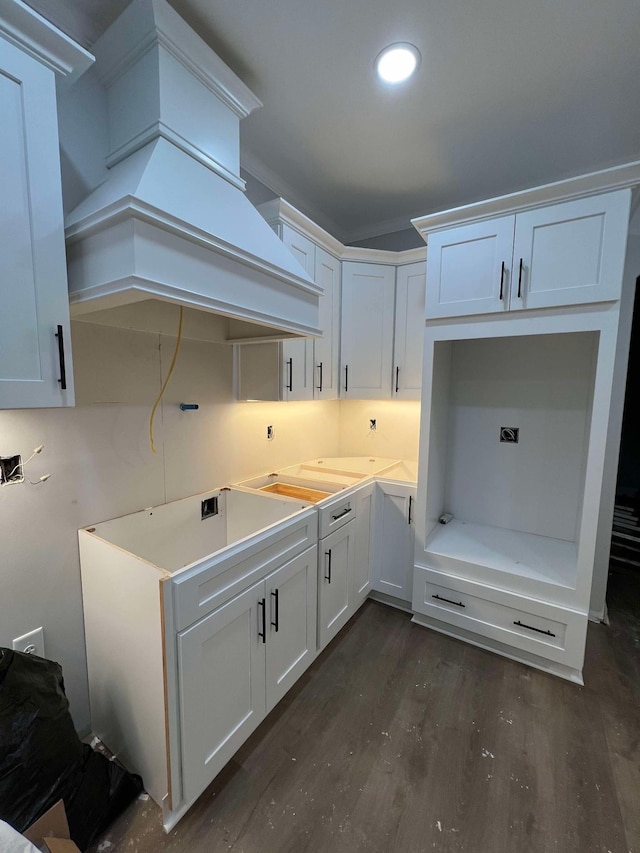 kitchen featuring white cabinetry, dark hardwood / wood-style floors, and custom range hood