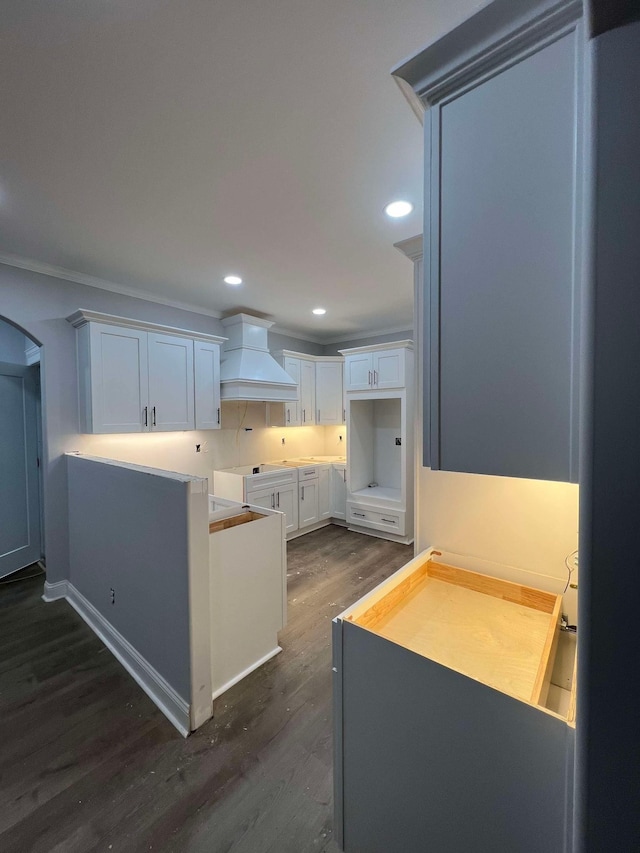 kitchen featuring custom range hood, white cabinets, and dark hardwood / wood-style flooring