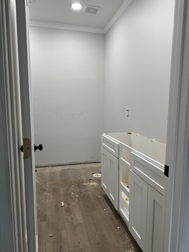 bathroom featuring crown molding and wood-type flooring