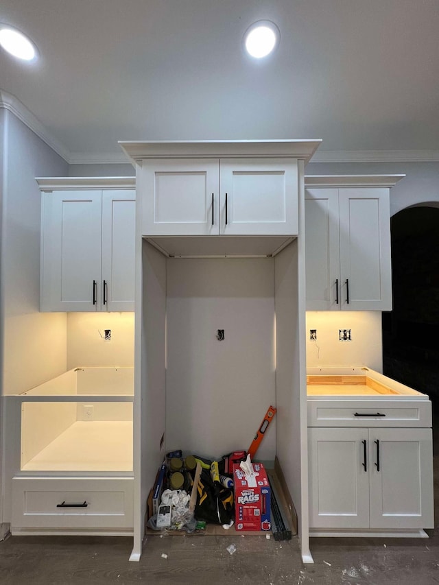 interior space featuring crown molding and white cabinets