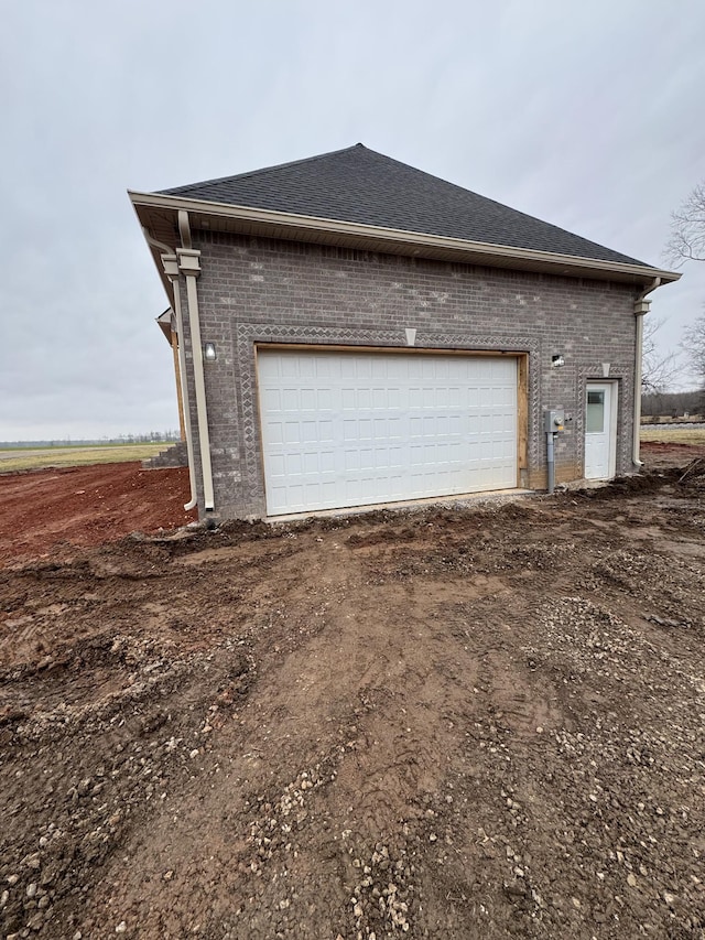 view of side of home featuring an outbuilding and a garage