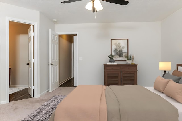 bedroom featuring a textured ceiling, ceiling fan, and carpet