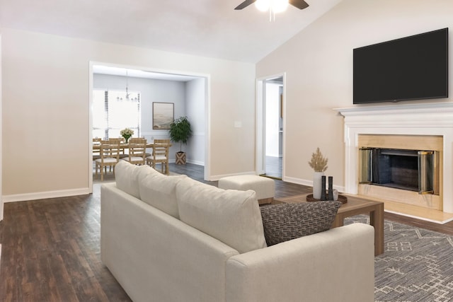 living room with ceiling fan with notable chandelier, vaulted ceiling, and dark hardwood / wood-style floors