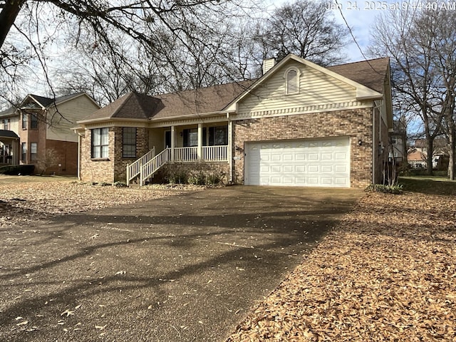 ranch-style house with a garage and covered porch