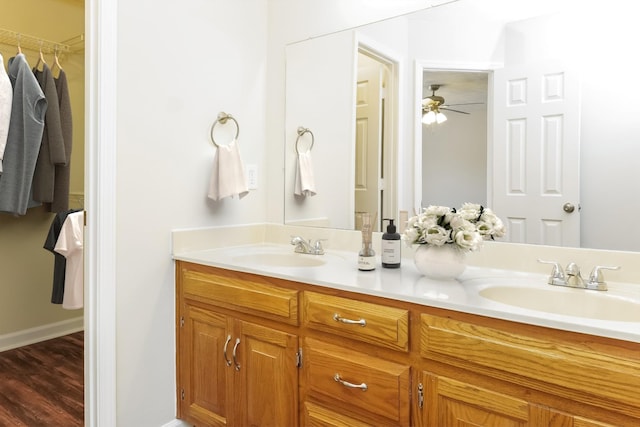 bathroom with hardwood / wood-style flooring, ceiling fan, and vanity