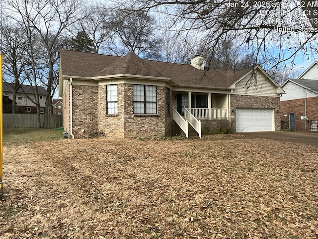 ranch-style house with a garage and covered porch