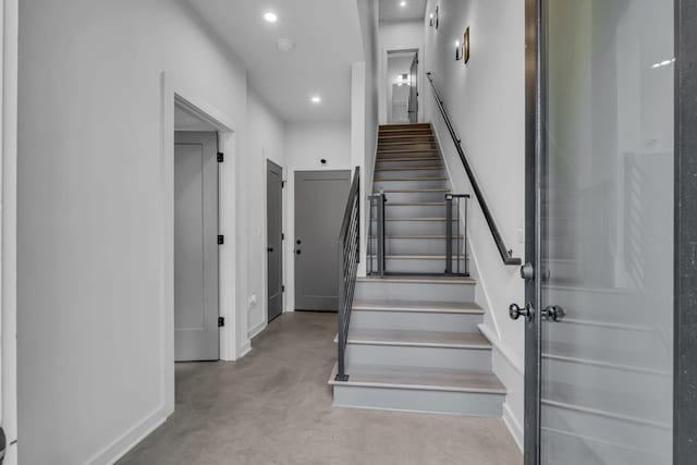 stairway featuring concrete flooring