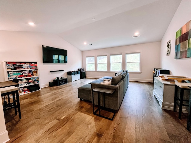 living room with lofted ceiling and light wood-type flooring