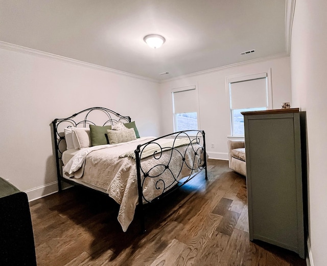 bedroom featuring ornamental molding and dark wood-type flooring