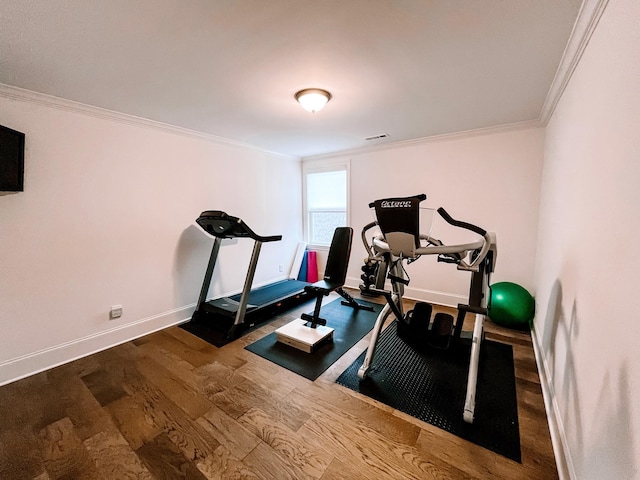 exercise area featuring hardwood / wood-style flooring and ornamental molding