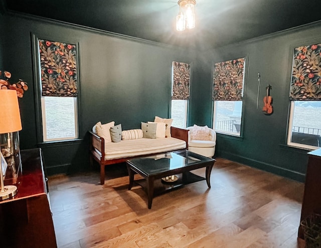 sitting room featuring crown molding, plenty of natural light, and light hardwood / wood-style flooring