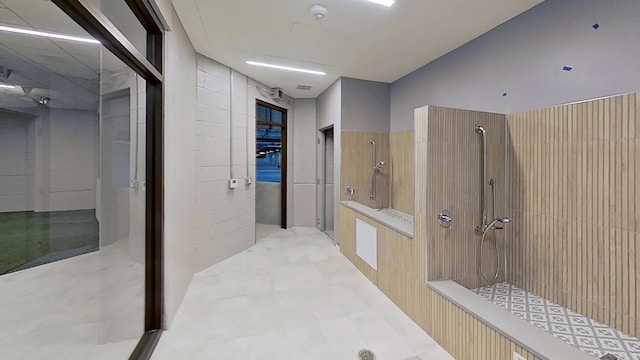 interior space with walk in shower and tile walls