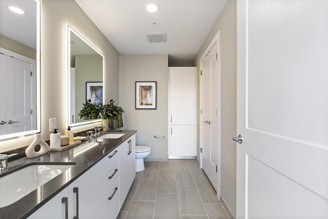 bathroom with vanity, toilet, and tile patterned flooring