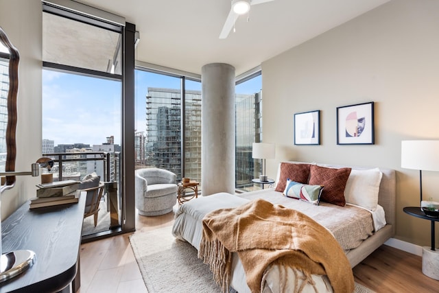 bedroom featuring ceiling fan, floor to ceiling windows, and light hardwood / wood-style flooring