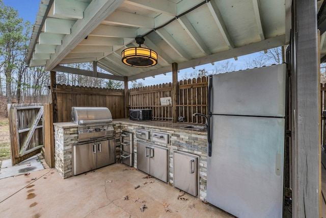 view of patio / terrace featuring a gazebo, area for grilling, sink, and ceiling fan