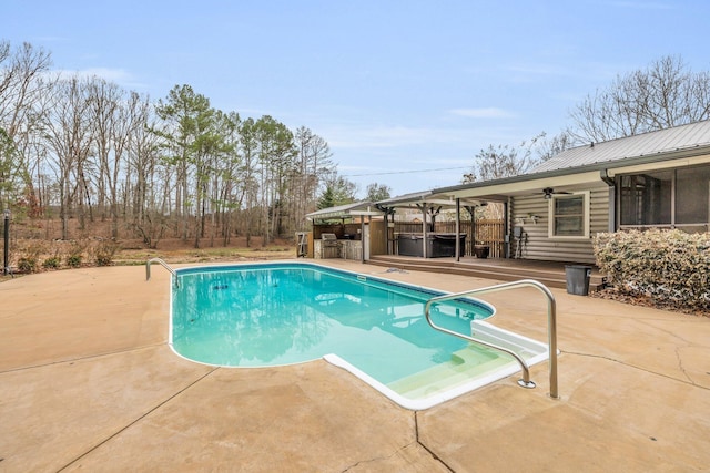 view of pool featuring a hot tub, a patio, and ceiling fan