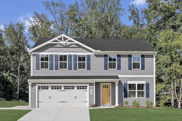 view of front of home featuring a garage and a front yard