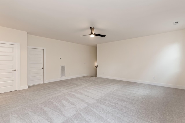 spare room with light carpet and ceiling fan