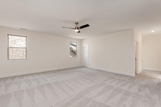 carpeted empty room featuring ceiling fan