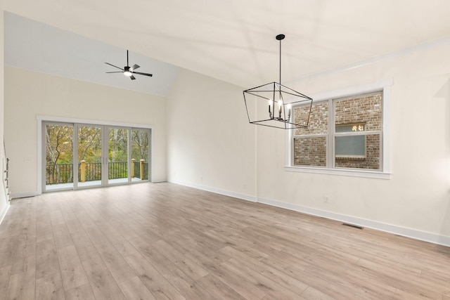 interior space with ceiling fan with notable chandelier, high vaulted ceiling, and light hardwood / wood-style floors