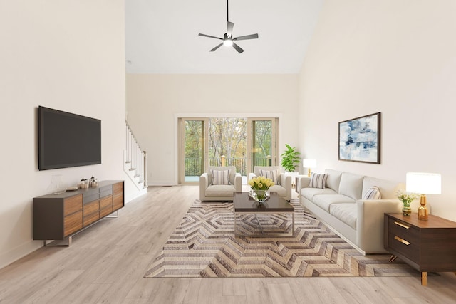 living room featuring ceiling fan, light hardwood / wood-style flooring, and a high ceiling