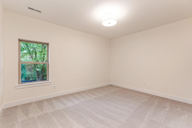 unfurnished room with light carpet