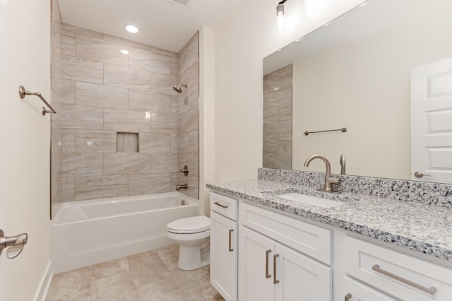 full bathroom featuring tiled shower / bath combo, vanity, and toilet