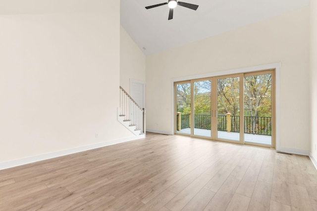 unfurnished living room featuring ceiling fan, high vaulted ceiling, and light wood-type flooring