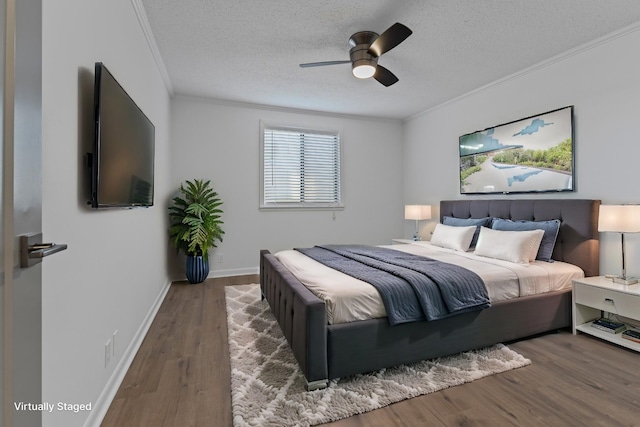 bedroom with crown molding, dark wood-type flooring, ceiling fan, and a textured ceiling