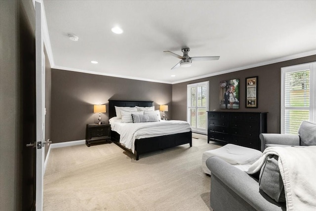 carpeted bedroom with ornamental molding and ceiling fan