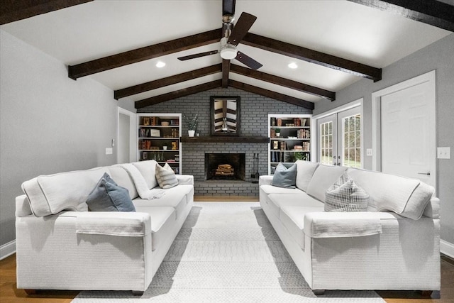 living room featuring french doors, ceiling fan, lofted ceiling with beams, and a brick fireplace