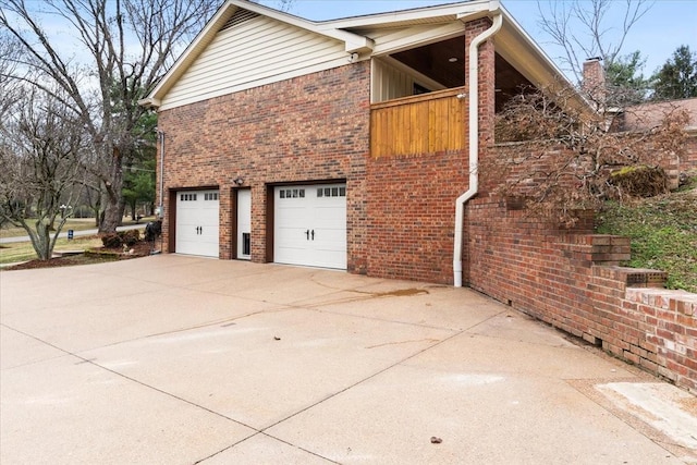 view of side of property with a garage and a balcony