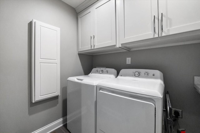 laundry room featuring cabinets and washer and dryer