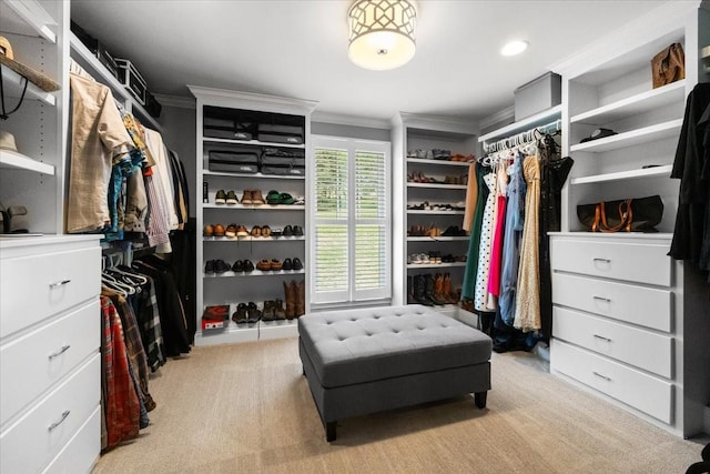 walk in closet featuring light colored carpet