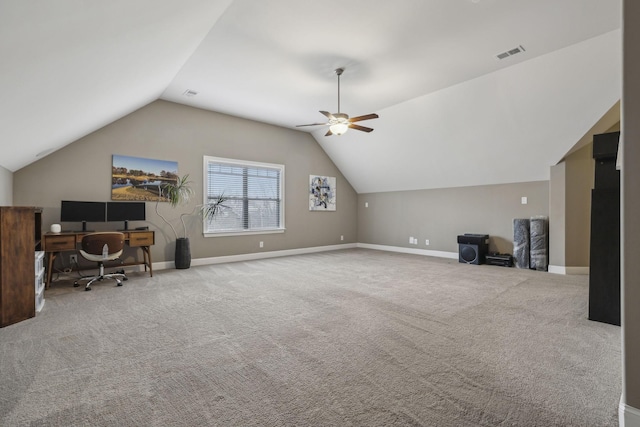 carpeted home office with ceiling fan and vaulted ceiling