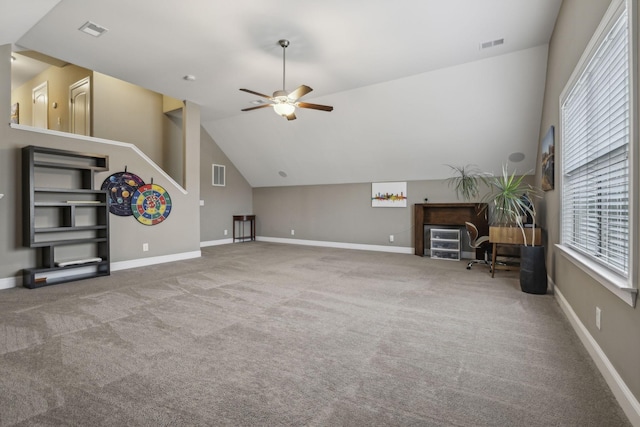 living room featuring ceiling fan, vaulted ceiling, and light carpet