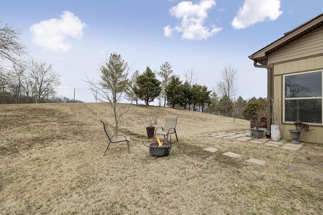 view of yard with an outdoor fire pit