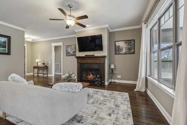 living room featuring crown molding, dark wood-type flooring, and ceiling fan