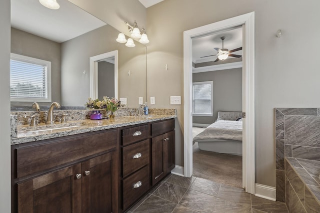 bathroom with vanity, ceiling fan, and a healthy amount of sunlight