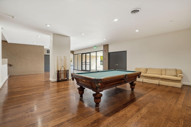 recreation room featuring brick wall, hardwood / wood-style floors, and pool table