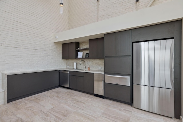 kitchen with a towering ceiling, dishwasher, and sink