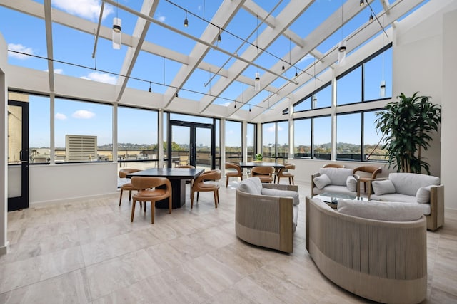 sunroom / solarium featuring a wealth of natural light and french doors