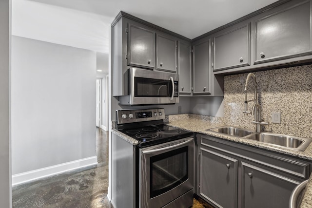 kitchen featuring stainless steel appliances, tasteful backsplash, and sink