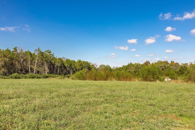 view of landscape with a wooded view