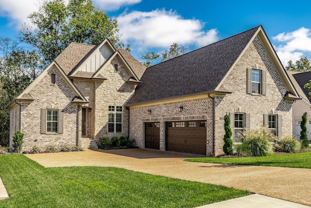 view of front of property featuring a garage and a front lawn