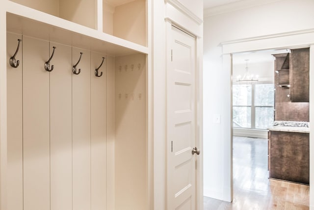 mudroom with baseboards and crown molding