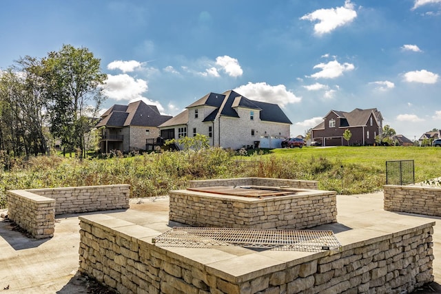 view of patio featuring an outdoor fire pit and a residential view