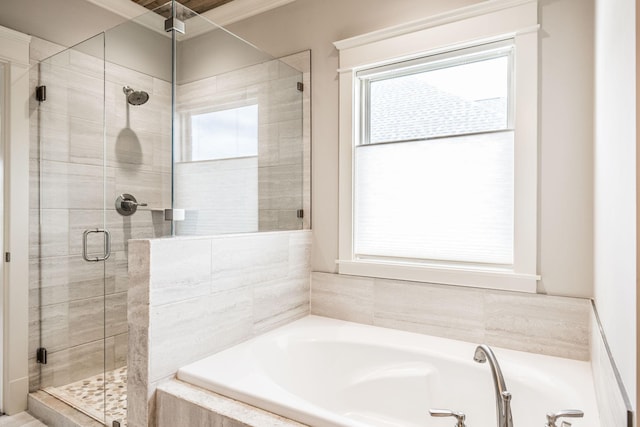 full bath with a wealth of natural light, a shower stall, and a bath