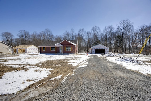 view of front facade featuring a detached garage and an outdoor structure